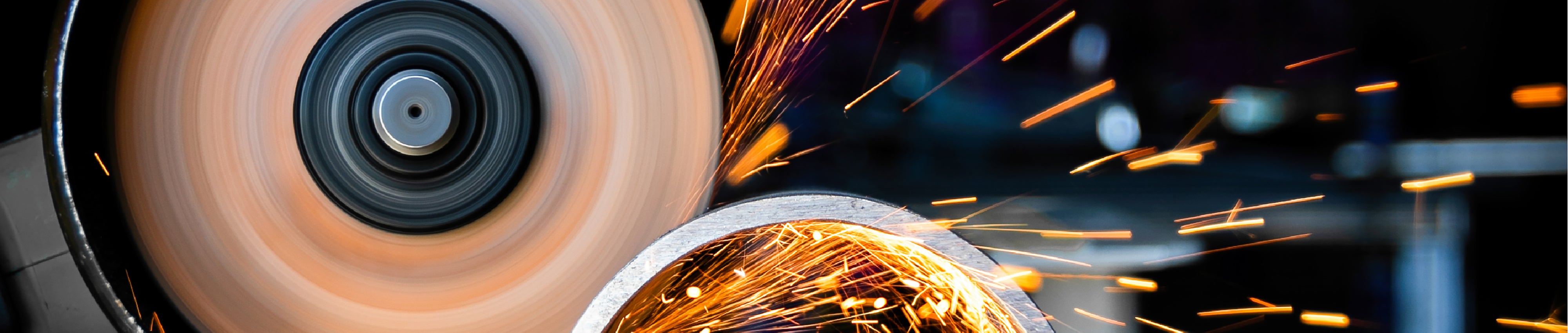 Close-up of a grinding wheel with sparks in a workshop setting