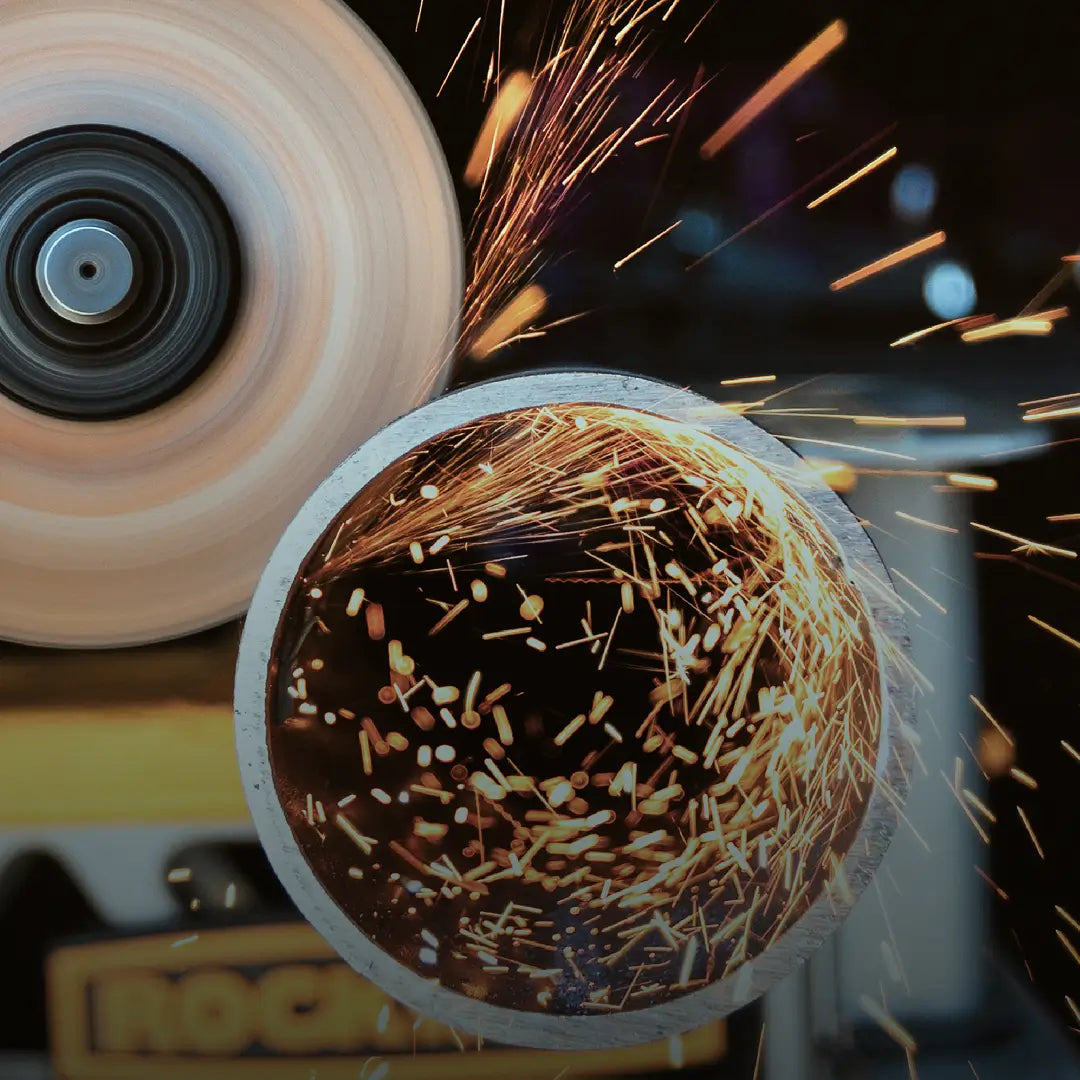 Angle grinder cutting a pipe