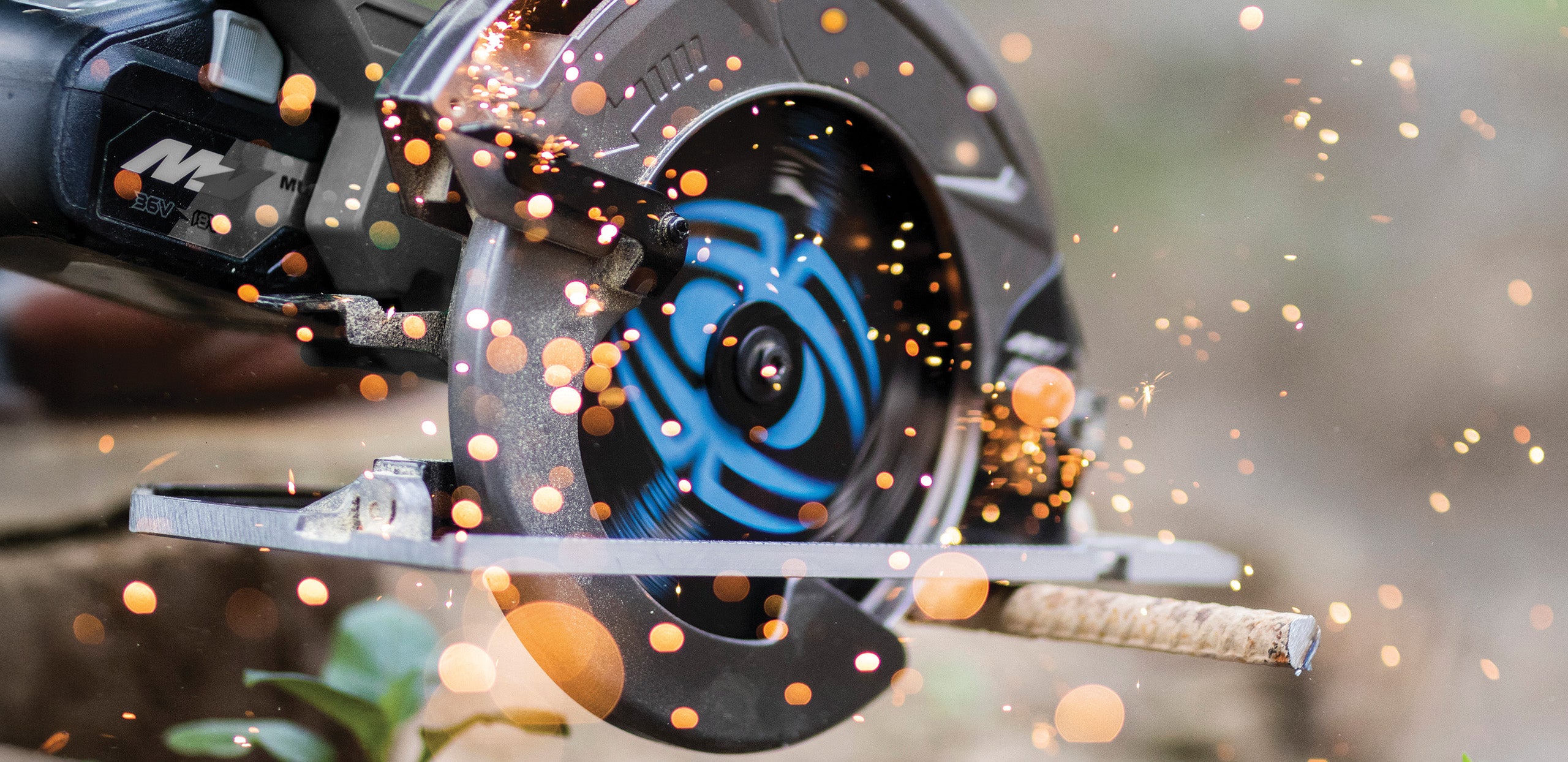 Circular saw cutting a piece of metal with sparks flying